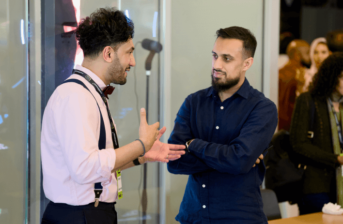 Image of Aqib in conversation at a networking event
