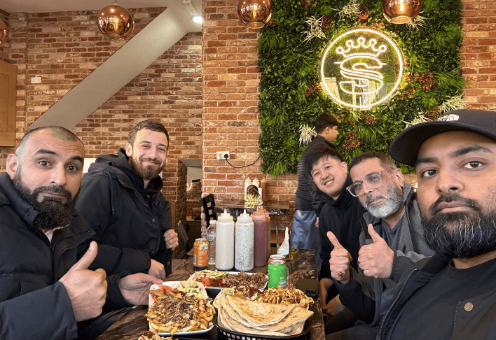 Image of Manza team at a meal together